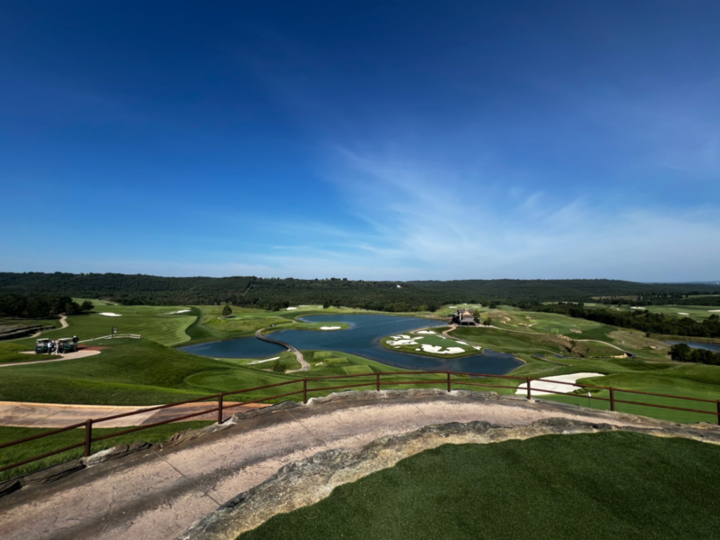 Elevated view from a rock outcrop over the ponds, bunkers and Ozark ridgelines at Big Cedar Lodge: Cliffhangers in Ridgedale, Missouri