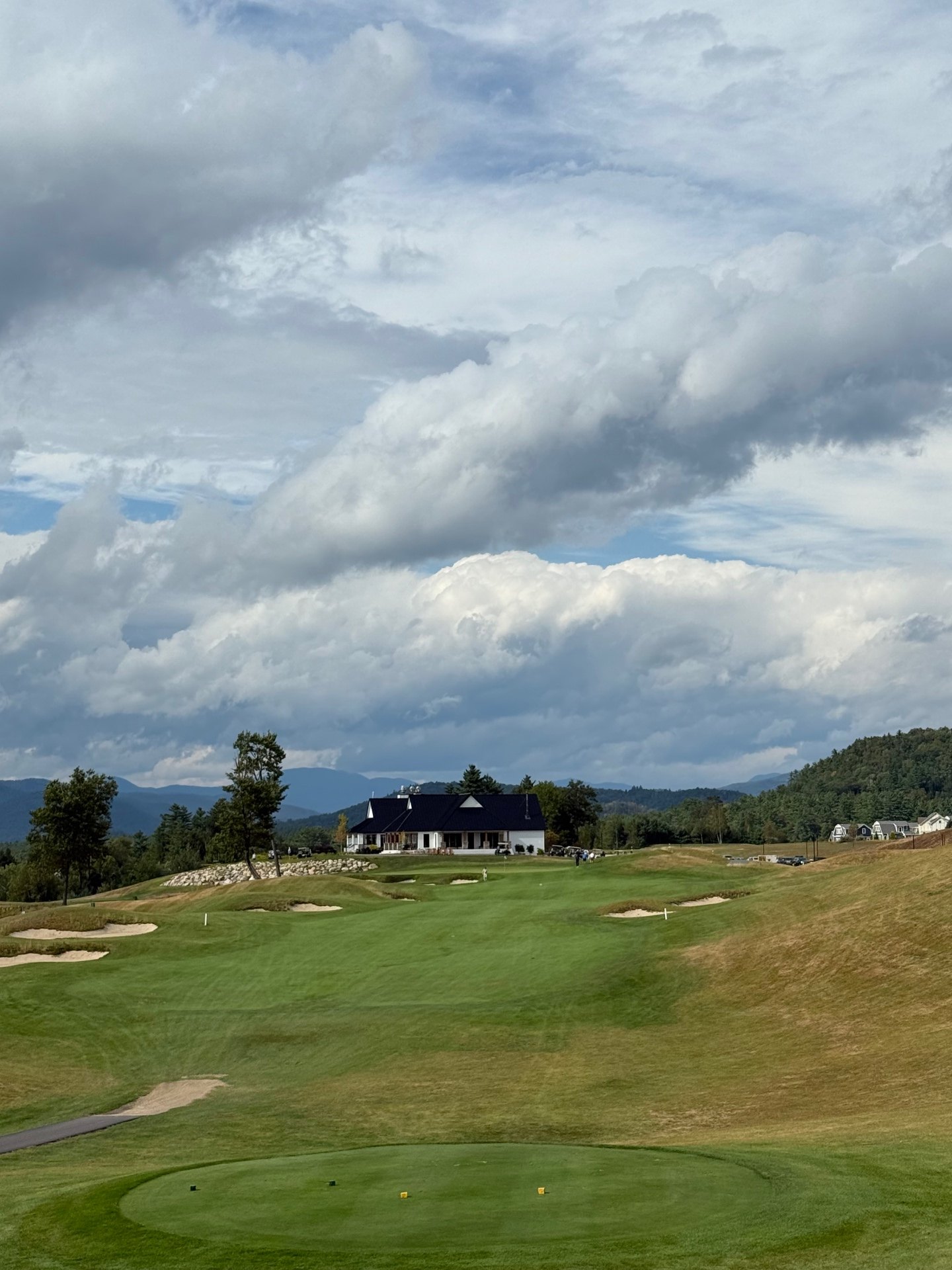 Approach view at Owl's Nest Resort Course with clubhouse and White Mountains beyond