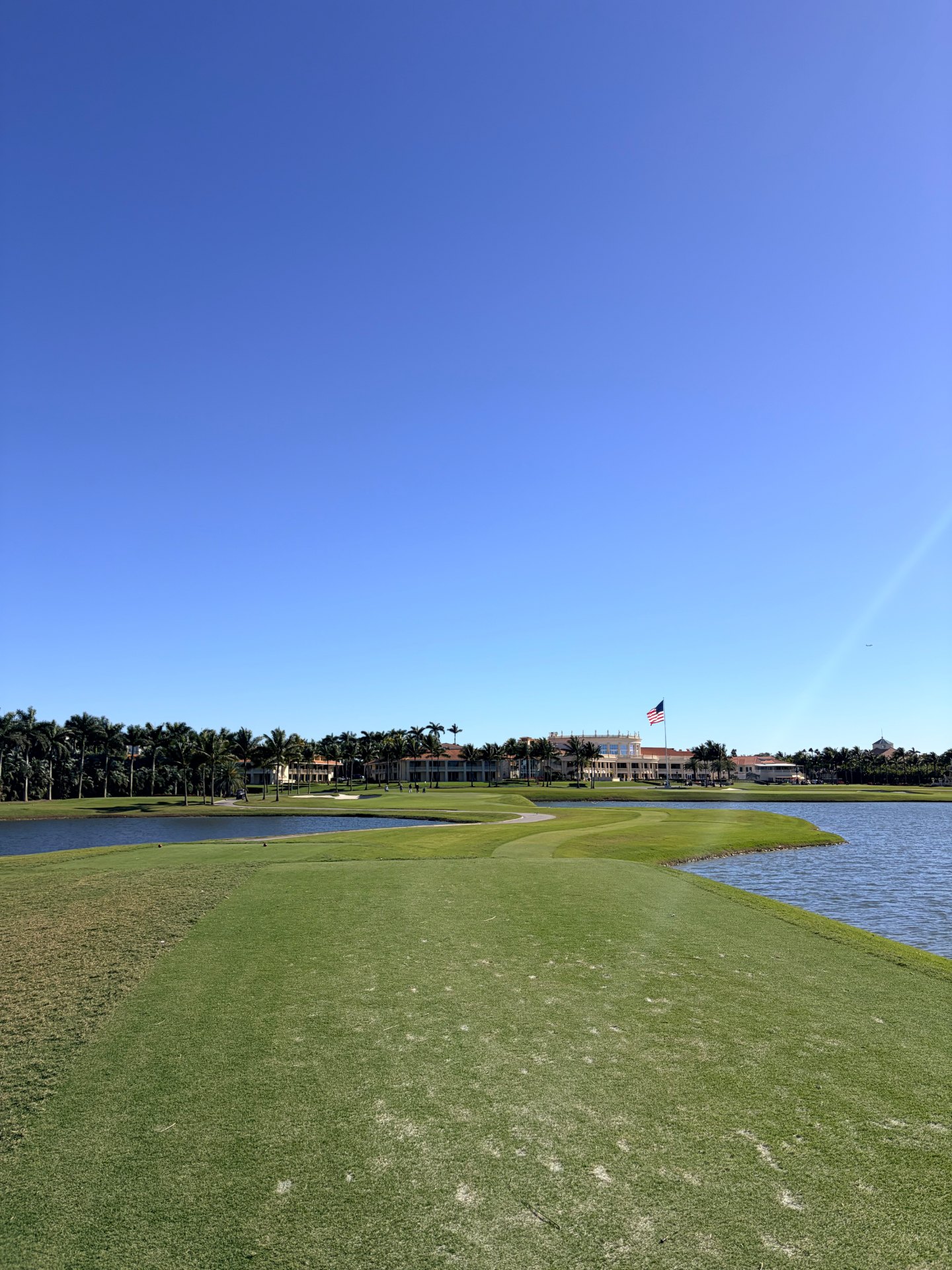 Blue Monster closing hole at Trump National Doral with water and clubhouse in the distance