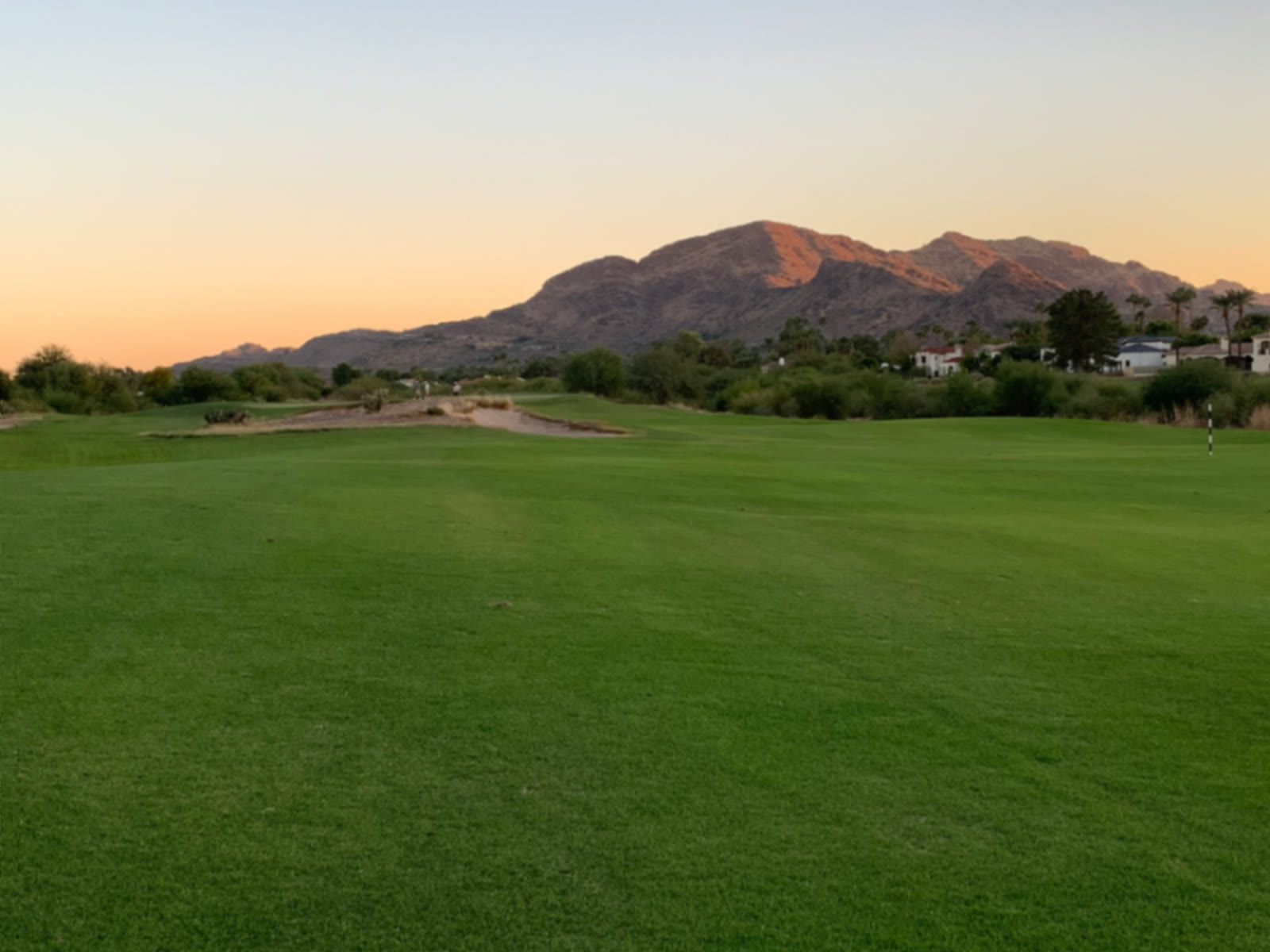 Fairway at sunset with desert mountains behind at Camelback Golf Club Ambiente course in Scottsdale, Arizona