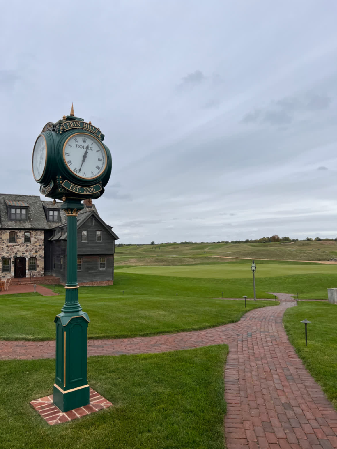 Erin Hills Golf Course — Erin, WI: the Rolex clock by the clubhouse with the fairways beyond